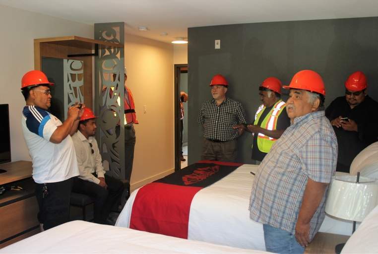 Chief and Council get a sneak peek of a staged room in Kwa’lilas Hotel, complete with artwork designed by local artists.